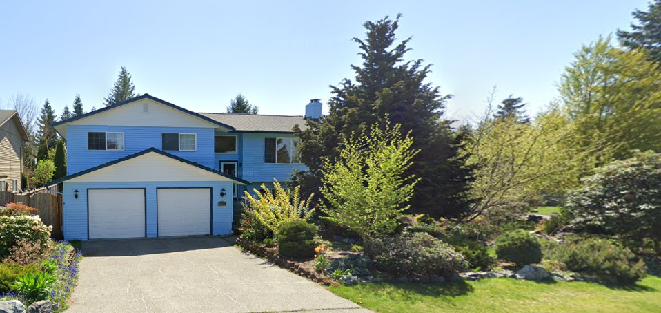 Marysville Acupuncture Clinic exterior entrance. A sky-blue house surrounded by a lush garden with convenient parking.